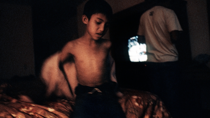 A young boy from Bhutan in a hotel room in Los Angeles, waiting to be transferred to his resettlement destination in 2008. A young boy from Bhutan in a hotel room in Los Angeles, waiting to be transferred to his resettlement destination in 2008.