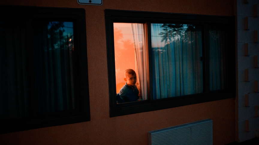 A young Burmese boy looked out from his hotel room in Los Angeles, shortly after arriving to the United States as a refugee. Photographed in June 2010. A young Burmese boy looked out from his hotel room in Los Angeles, shortly after arriving to the United States as a refugee. Photographed in June 2010.