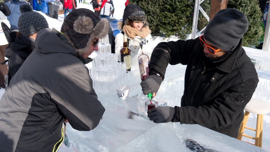 Bellying up to the ice block on Quebec's carnival grounds. “Don't put your change on the bar,” the bartender tells a customer. “It will stick. And don't even think about your tongue.” Bellying up to the ice block on Quebec's carnival grounds. “Don't put your change on the bar,” the bartender tells a customer. “It will stick. And don't even think about your tongue.”