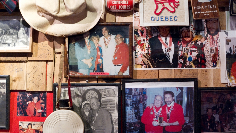An old-style caribou flask hangs on the wall with historic photos at the Voûte à 'Ti-Père. An old-style caribou flask hangs on the wall with historic photos at the Voûte à 'Ti-Père.