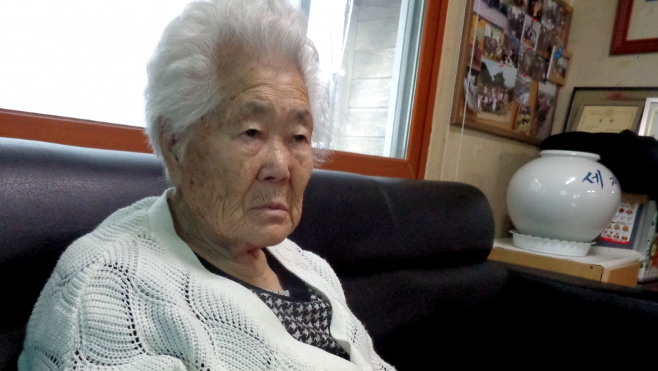 Ok-Seon Yi says she was 15 years old when soldiers abducted her and brought to a “comfort station,” or military brothel. Now ,she is 87 years old and lives in a home for the survivors outside of Seoul. Ok-Seon Yi says she was 15 years old when soldiers abducted her and brought to a “comfort station,” or military brothel. Now ,she is 87 years old and lives in a home for the survivors outside of Seoul.