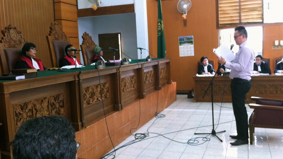 Benny Handoko reads his defense statement in front of a panel of judges in a Jakarta courtroom. Benny Handoko reads his defense statement in front of a panel of judges in a Jakarta courtroom.