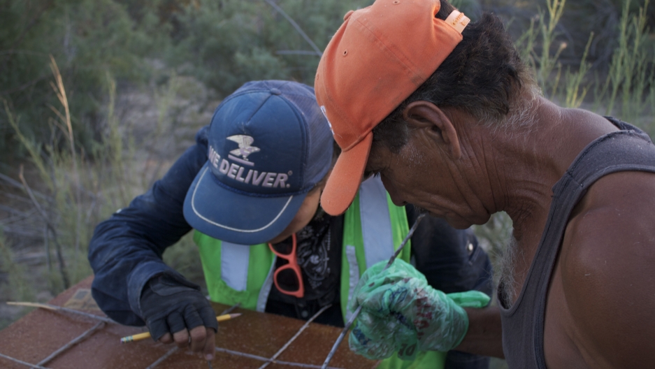 Alejandra Calvo and Juan Butrón, from the Mexican environmental organization, Pronatura, examine a seed trap.