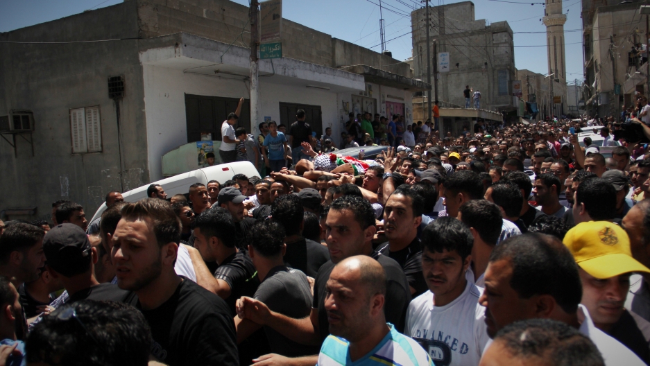 Palestinians carry the body of 17-year-old Mohammed Al-Araj through the streets of the Qalandiya refugee. He was killed in clashes with the Israeli Army. Palestinians carry the body of 17-year-old Mohammed Al-Araj through the streets of the Qalandiya refugee. He was killed in clashes with the Israeli Army.