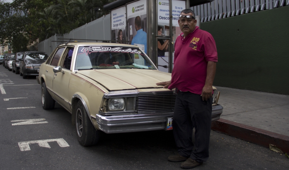 William Rivas drives his own Chevy Malibu as cab. Gas prices are so low in Venezuela that it costs him less than $1 to fill up the tank.