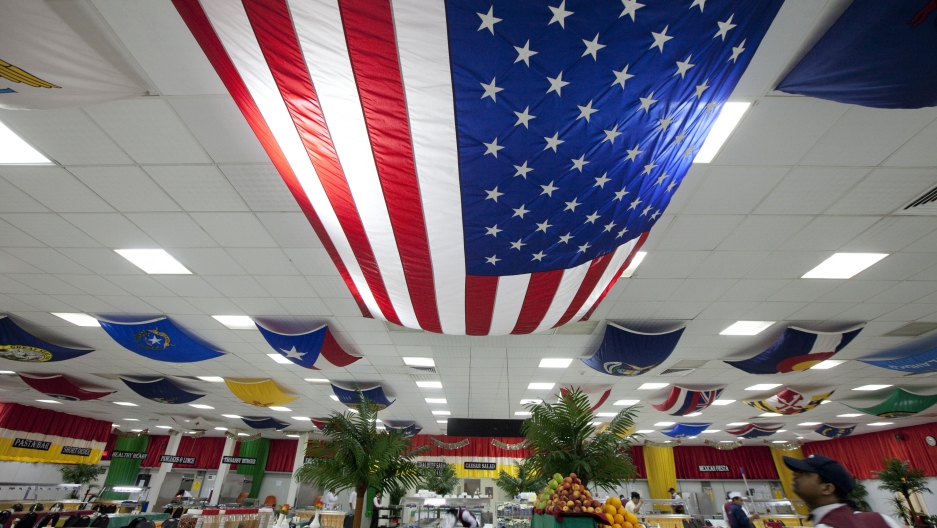 A U.S. flag hangs over fake palm trees inside the compound of the U.S. embassy in Baghdad in 2011.