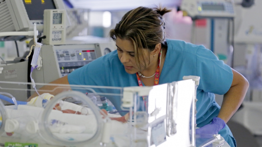 A nurse attends to an infant in the neonatal intensive care unit of the Holtz Children's Hospital at Jackson Memorial Hospital in Miami.