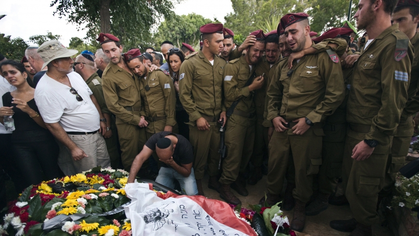 Israeli soldiers mourn the death of their fallen comrade, Bnaya Rubel during his funeral in Holon, Israel  on July 20, 2014. 