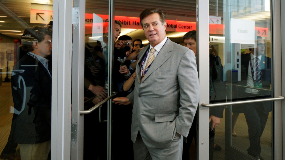 Paul Manafort, then-campaign manager to Donald Trump, escaping a mob of reporters in Cleveland, Ohio, on July 14, 2016.