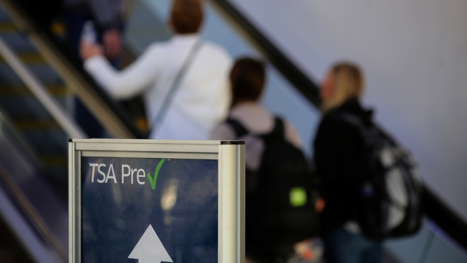 TSA Pre-check sign in front of escalator