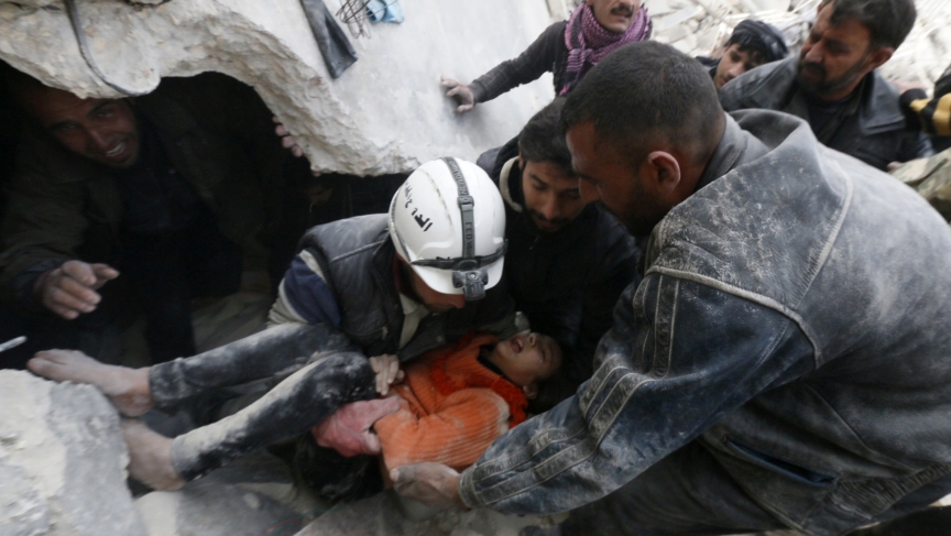 Residents and activists pull a girl from under debris after what activists said were explosive barrels dropped by forces loyal to Syria's President Bashar al-Assad in Aleppo, Syria on February 2, 2014. 