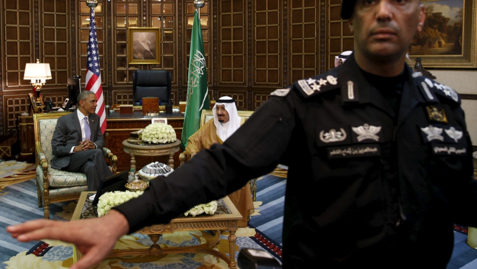 A guard ushers away photographers as President Barack Obama meets with Saudi King Salman in Riyadh, Saudi Arabia April 20, 2016