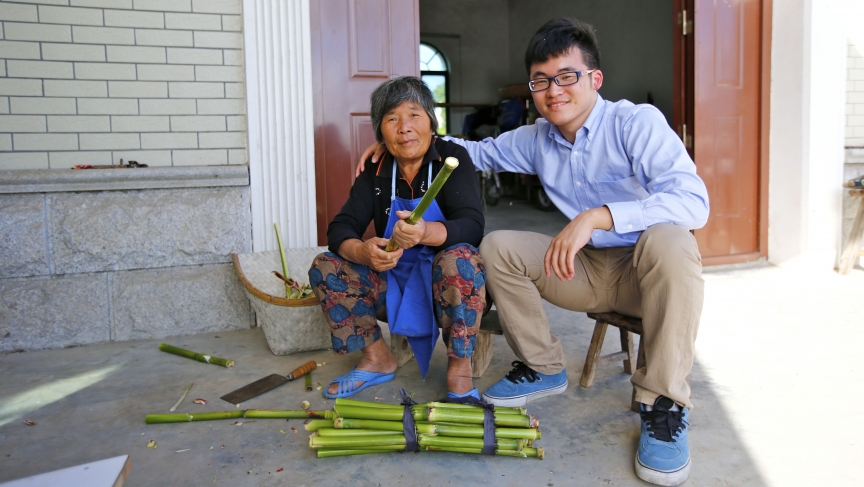 Gu Hangyu, sits with his grandmother Wang Yufang, at her home on Chongming Island near Shanghai. She speaks the Chongming dialect, but not standard Chinese.