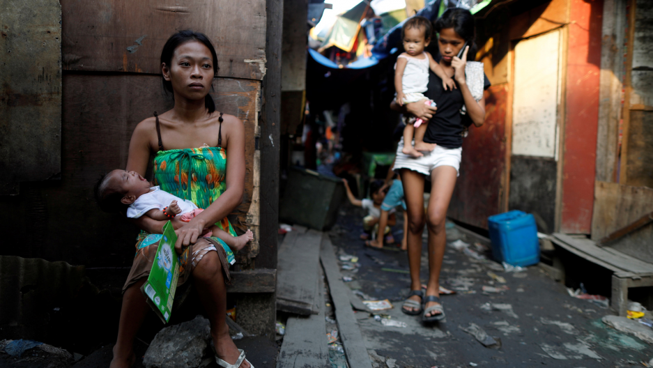 Residents are seen outside their shanties in Navotas, Metro Manila, Philipp...