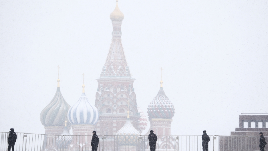 Police block access to the Red Square during a snowfall