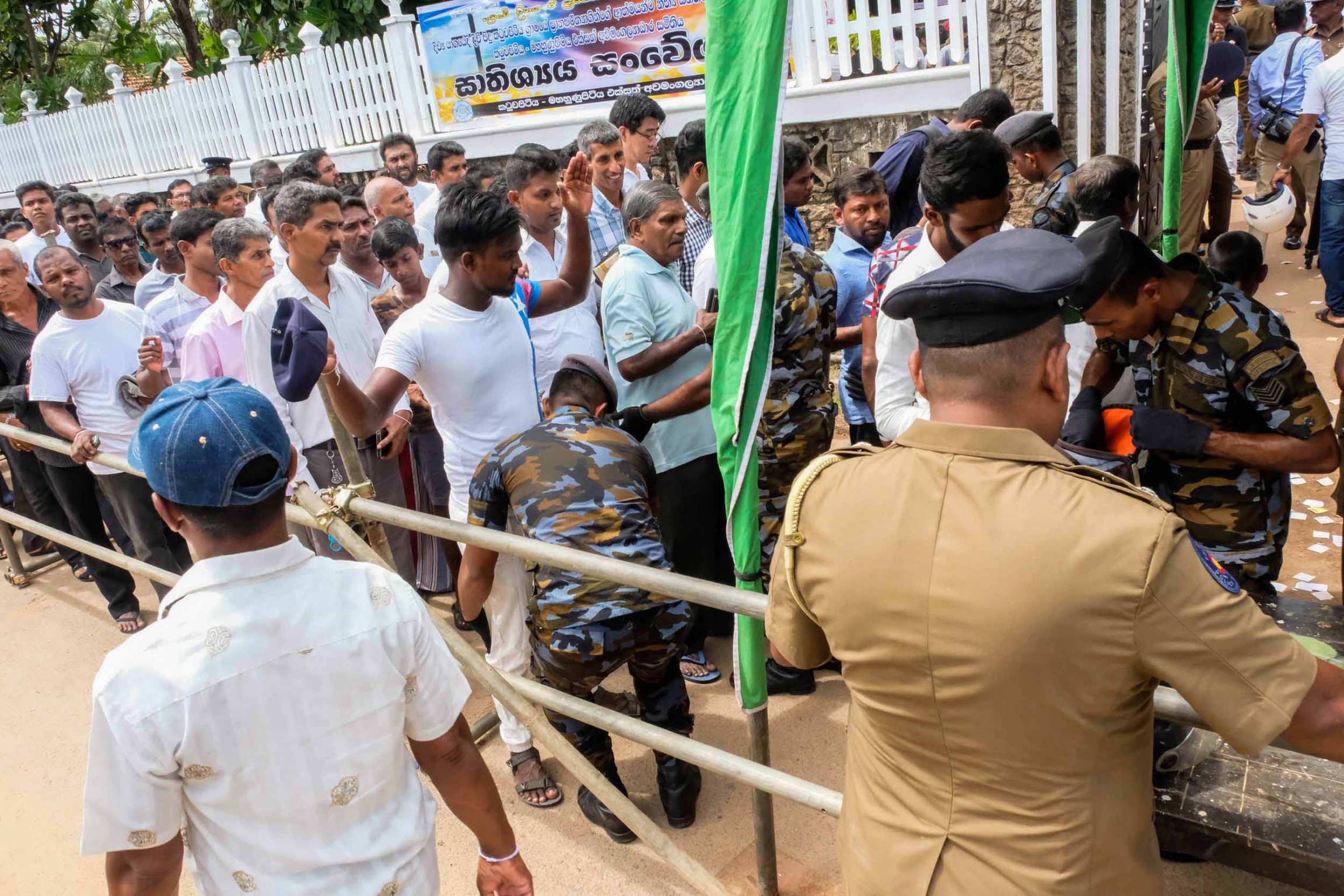 Security checks mourners for weapons