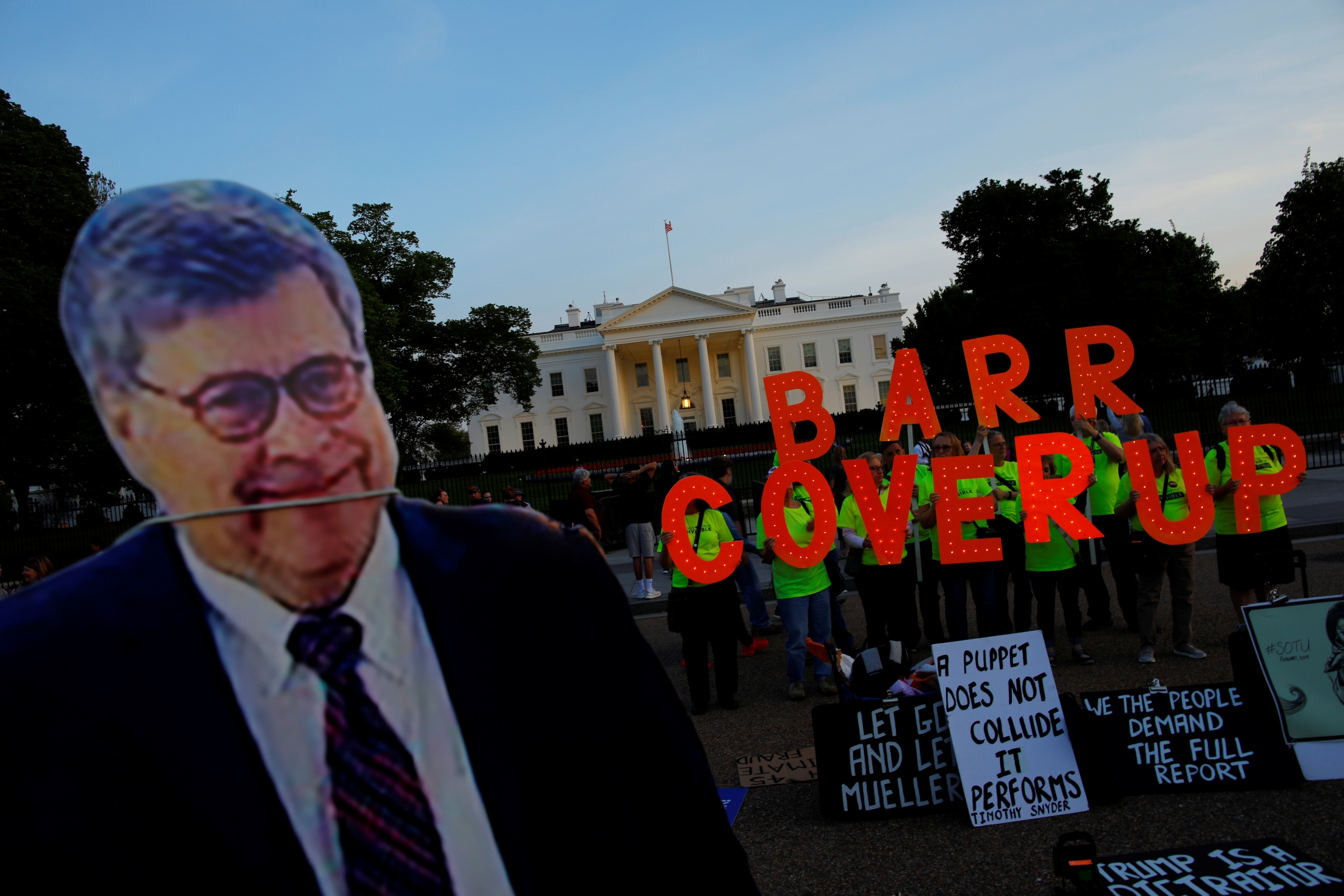 A cardboard cutout of US Attorney General William Barr is seen as protesters hold signs which read "Barr Coverup," following the release of the Mueller report on President Donald Trump at the White House in Washington, DC, April 18, 2019. A cardboard cutout of US Attorney General William Barr is seen as protesters hold signs which read "Barr Coverup," following the release of the Mueller report on President Donald Trump at the White House in Washington, DC, April 18, 2019.