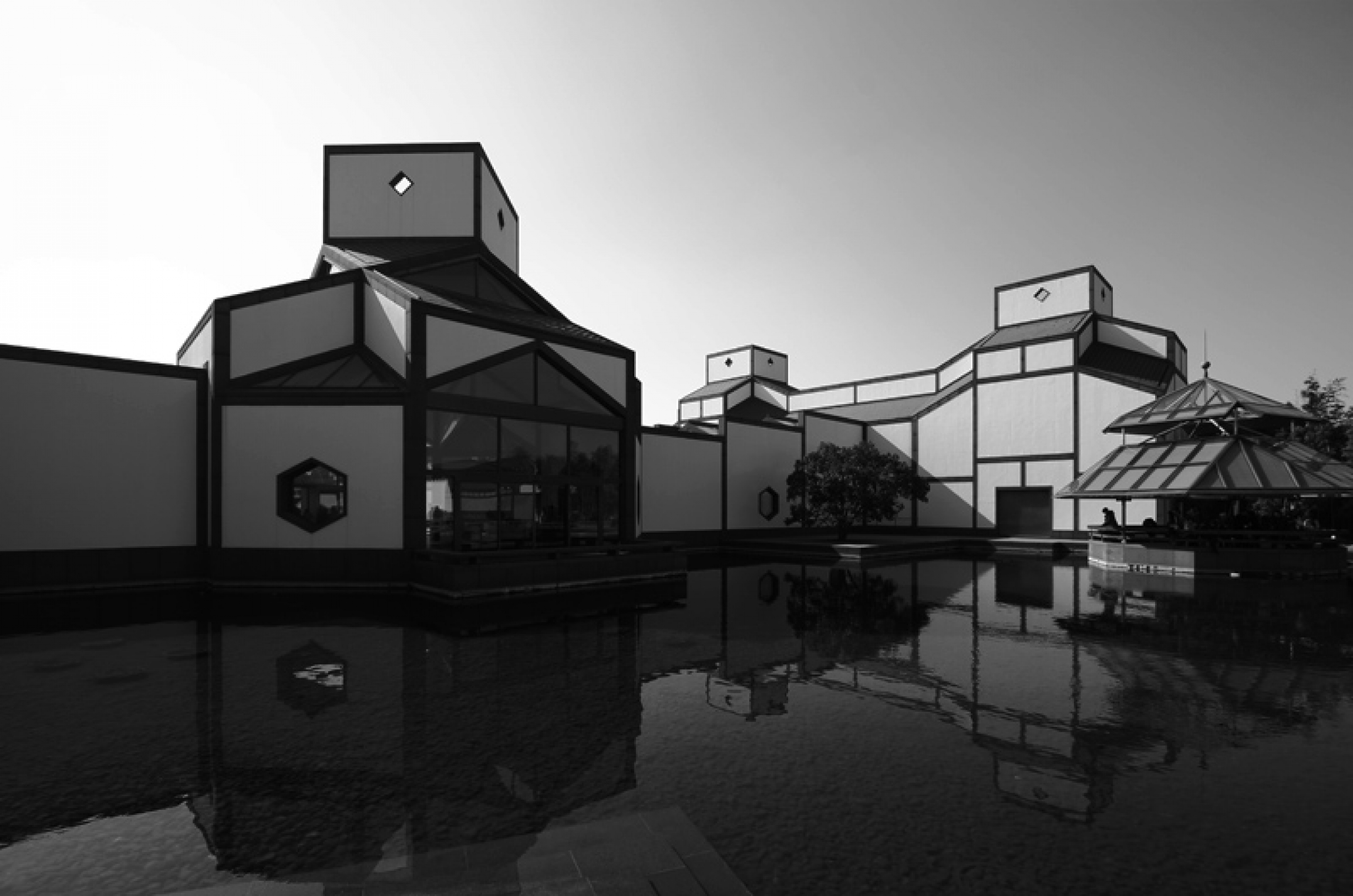 Pei finished rebuilding the Suzhou Museum in 2006. A black and white photo of the Suzhou Museum next to water.