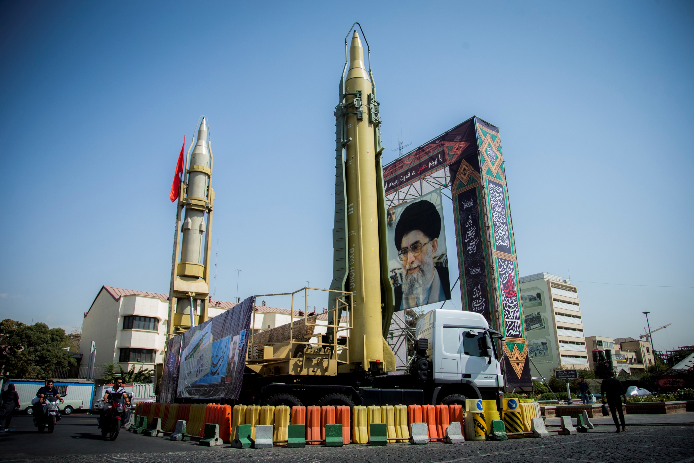 A display featuring missiles and a portrait of Iran's Supreme Leader Ayatollah Ali Khamenei is seen at Baharestan Square in Tehran, Iran. A display in an Tehran shows a portrait of Ayatollah Khamenei and two missiles.