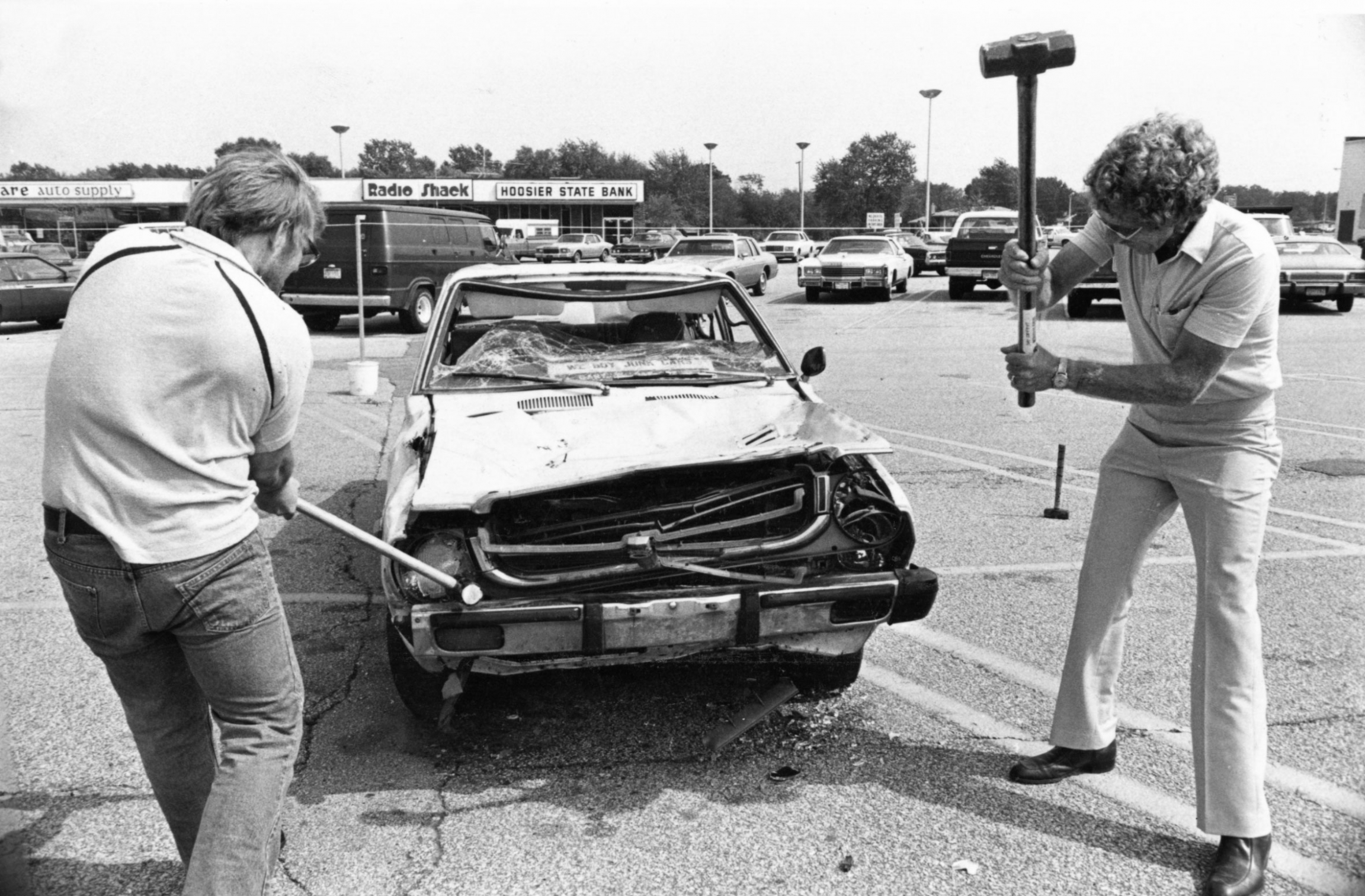 Auto worker Jim Coleman (left) and businessman Charlie Cobb (right) swing sledgehammers in Indiana at a Japanese-made car for $1 a shot. The money went to help the families of laid-off workers, Friday, Sept. 10, 1982. Auto worker Jim Coleman (left) and businessman Charlie Cobb (right) swing sledgehammers in Indiana at a Japanese-made car for $1 a shot. The money went to help the families of laid-off workers, Friday, Sept. 10, 1982.