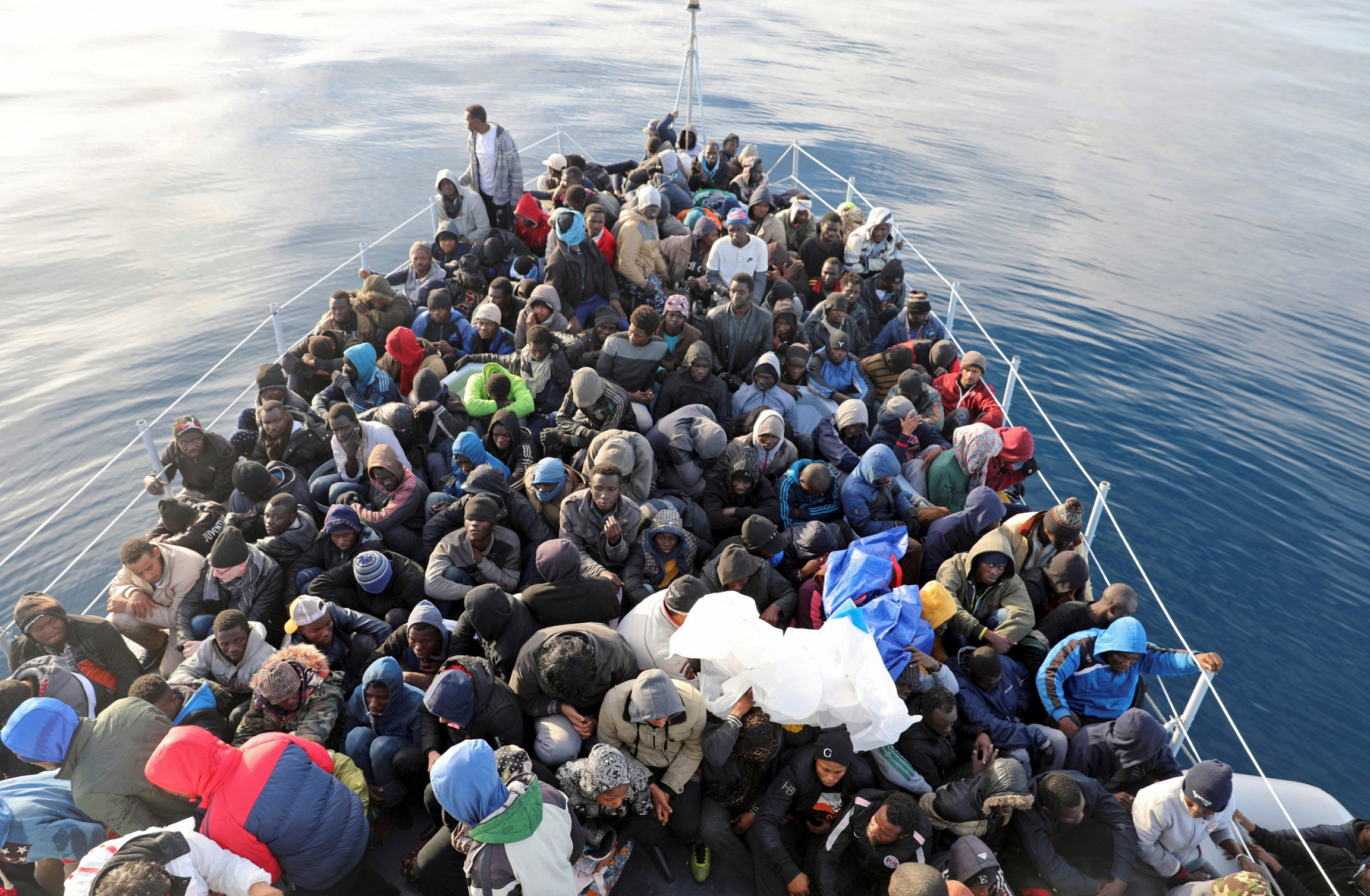 Migrants are seen in a boat as they are rescued by Libyan coast guards in the Mediterranean Sea off the coast of Libya, in January 2018. The front of a boat is packed full with migrants who have been rescued in the Mediterranean.