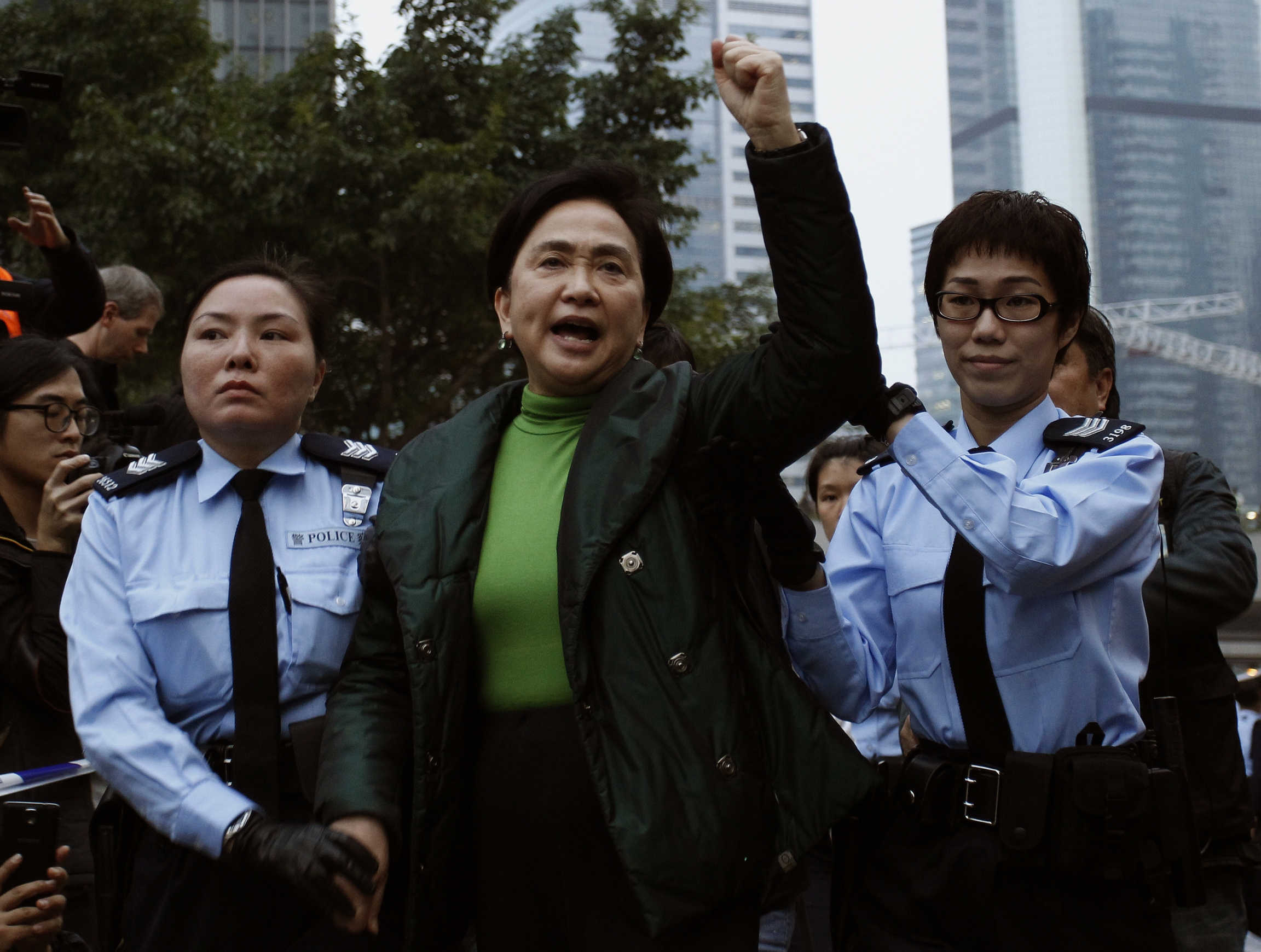 Emily Lau chants slogans as she is taken away by the police outside the government headquarters in Hong Kong December 11, 2014.