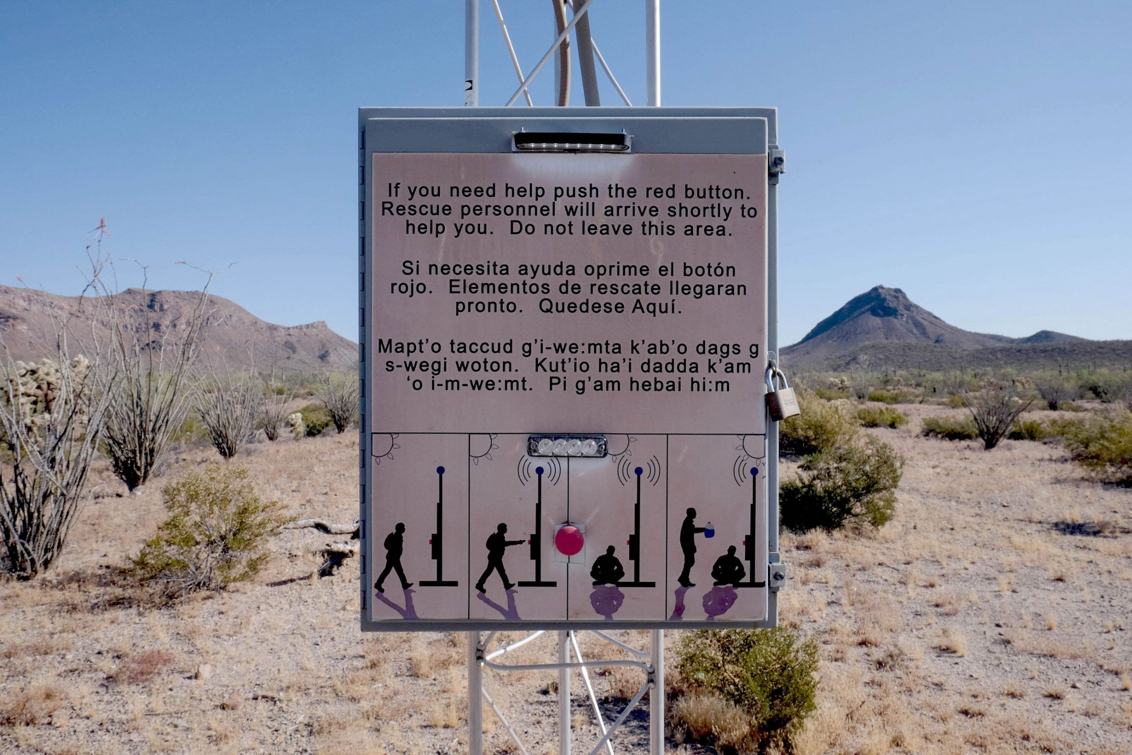 A sign in a wilderness area outside of Ajo, where volunteers often hike. A sign in the desert reads, "If you need help push the red button. Rescue personnel will arrive shortly to help you. Do not leave this area."