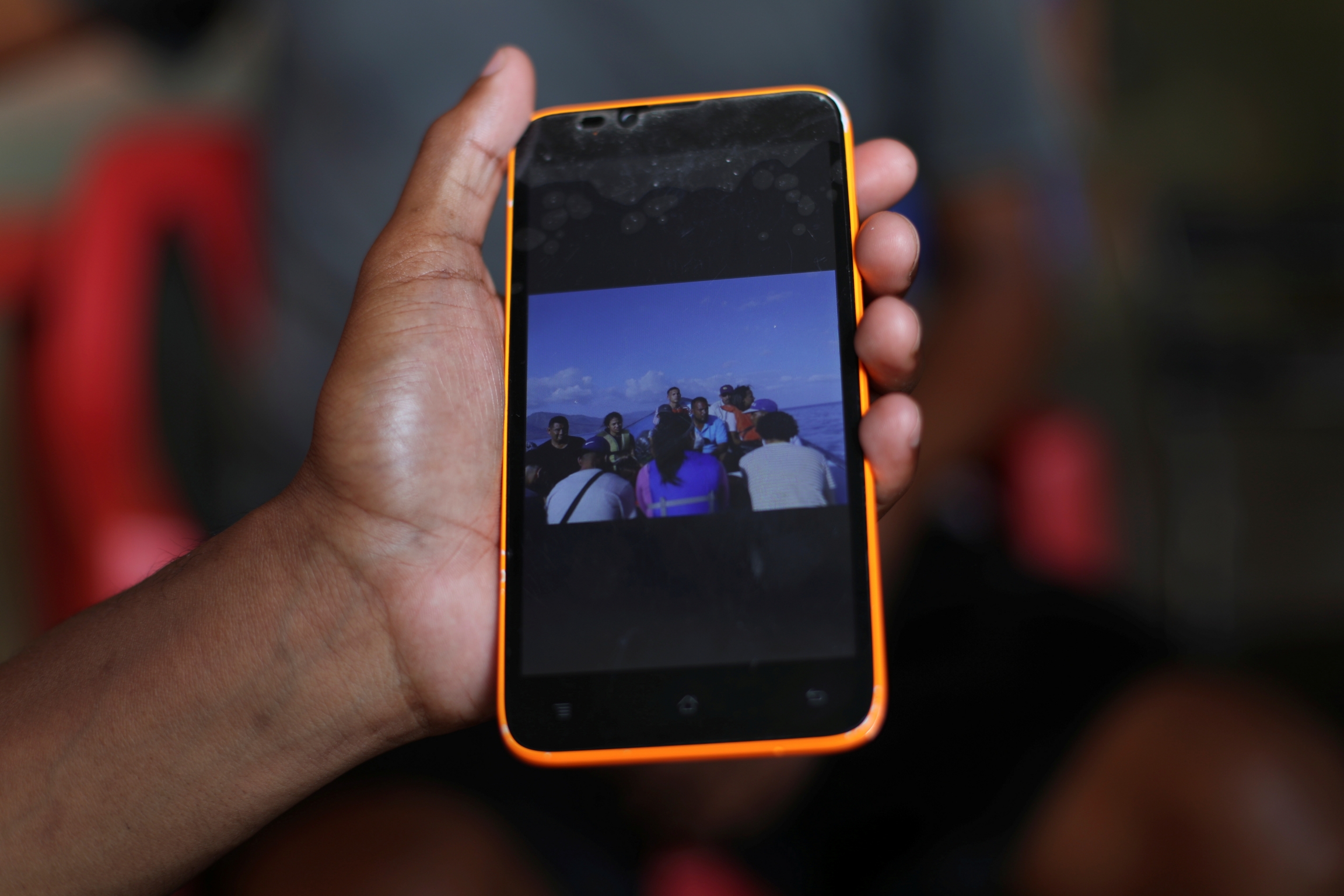 A friend of Maroly shows a picture of the boat that Maroly and her family boarded.
