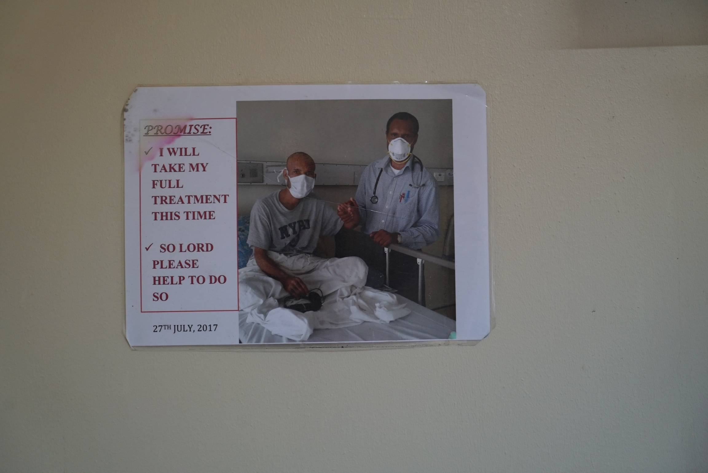 An image of a TB patient and his doctor hung on a wall