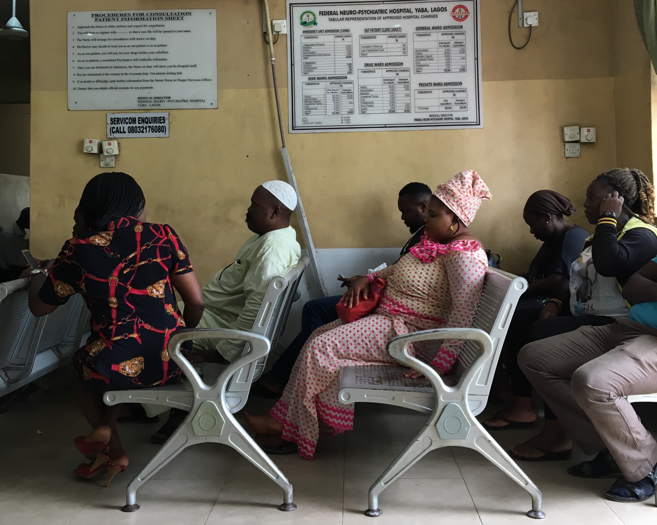 Patients wait in chairs at a mental hospital