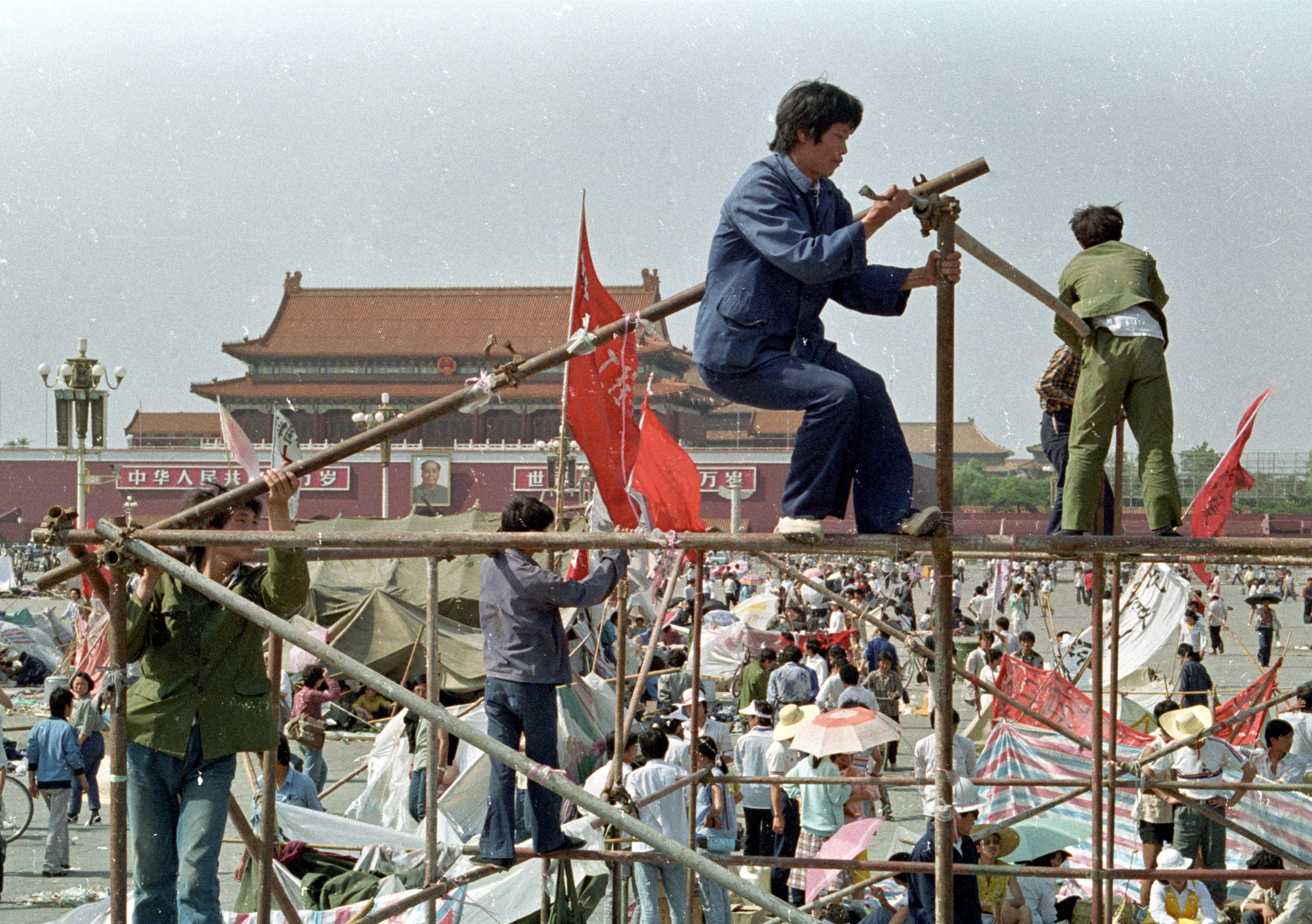 Protesters construct tents in Tiananmen Square to protect themselves from the elements on May 26, 1989. Students prop up wooden poles to build tents in Tiananmen Square.