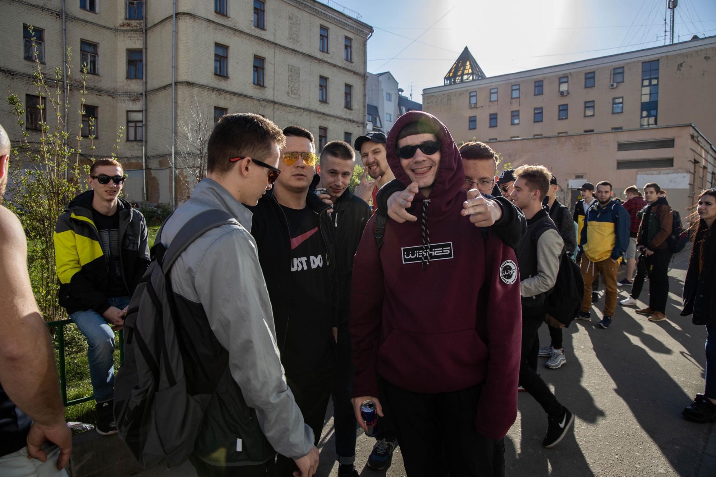 Vitaly Kobziv (center), from Ukraine, has been rapping for about five years. A group of young men stand outside in Russia.