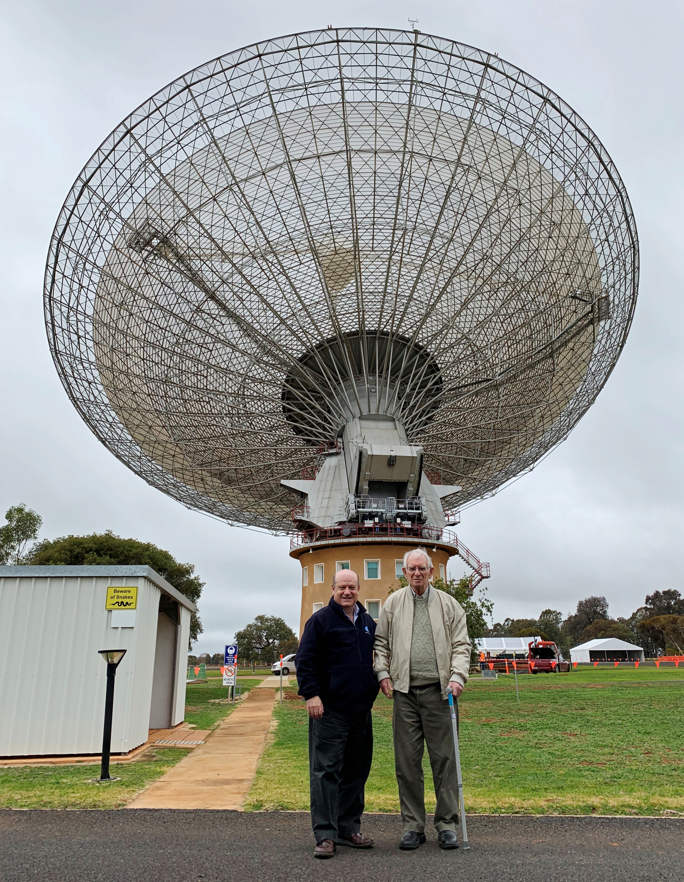 John Sarkissian and David Cooke at Parkes Observatory. two men stand in front of an observatory