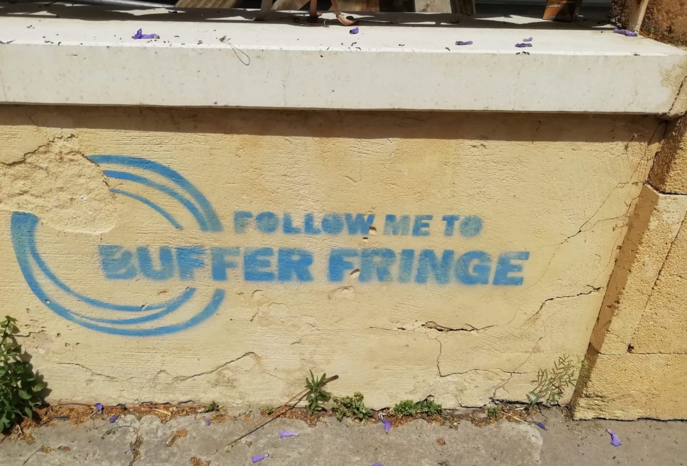 Graffiti seen on wall in Nicosia in blue lettering reads "Follow Me to Buffer Fringe" 