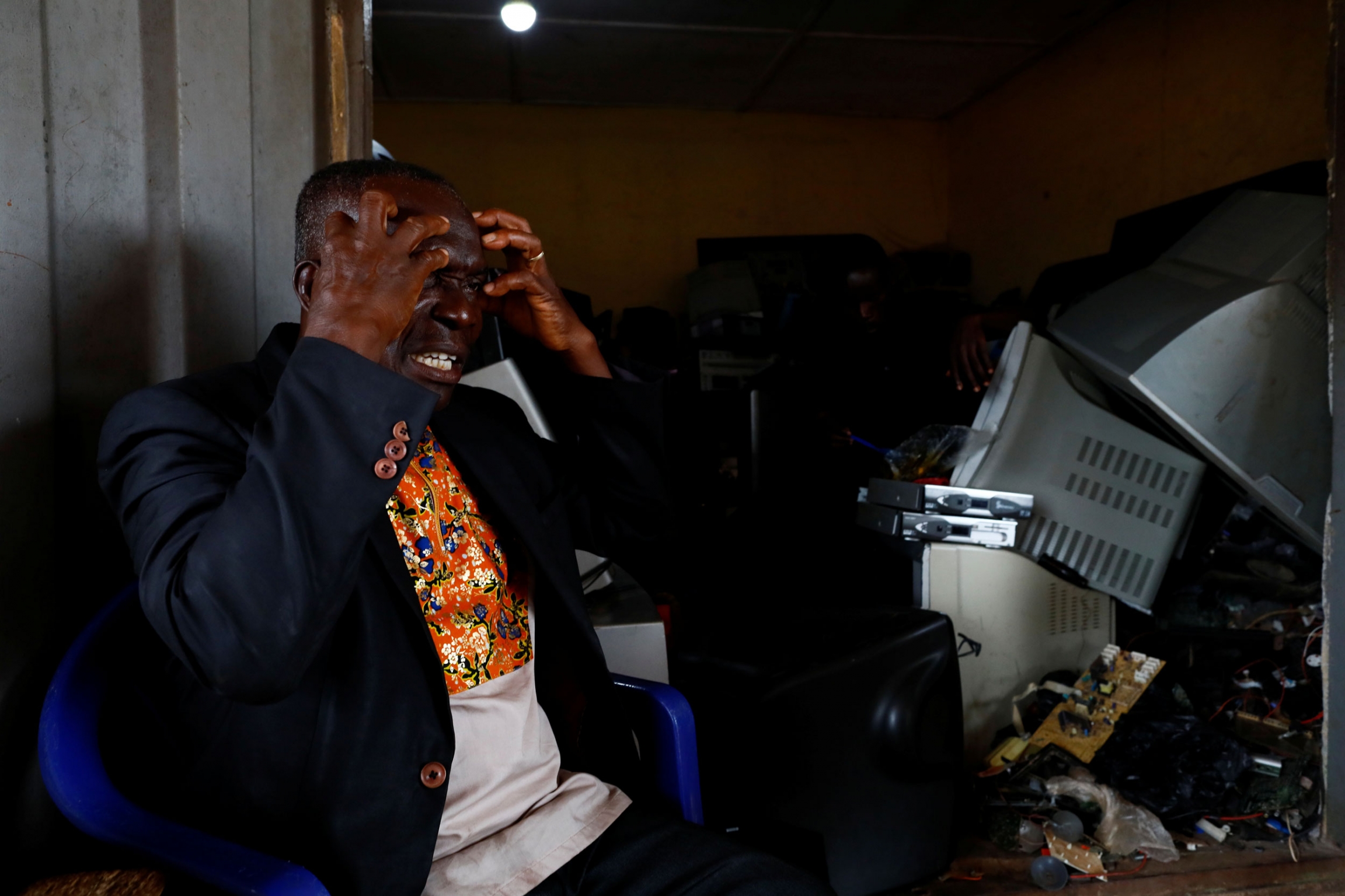 Agyei tells the story of slave trade. A man is shown with his hands to his face and wearing a dark blazer.