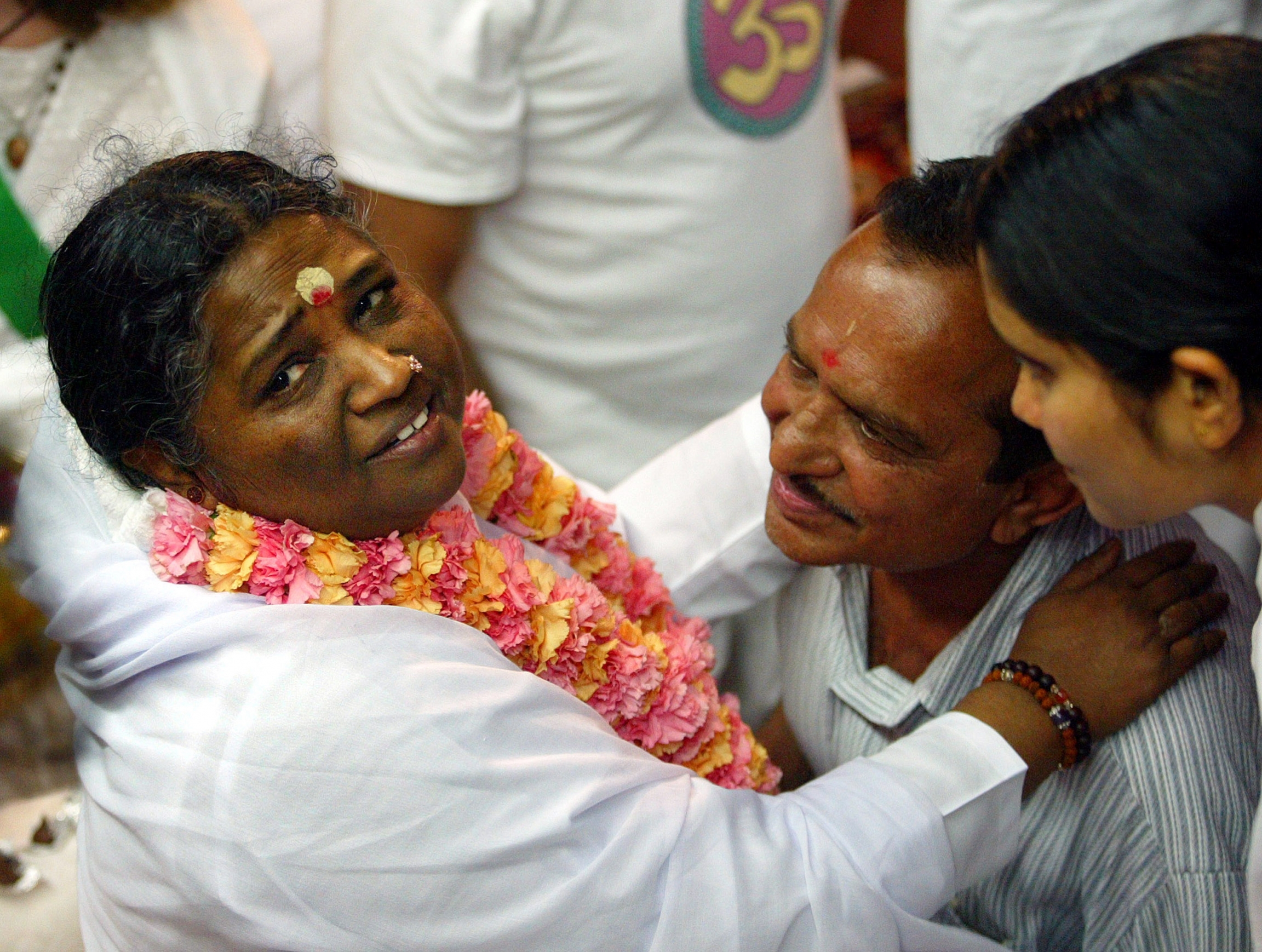 A man gets a hug from Amma.