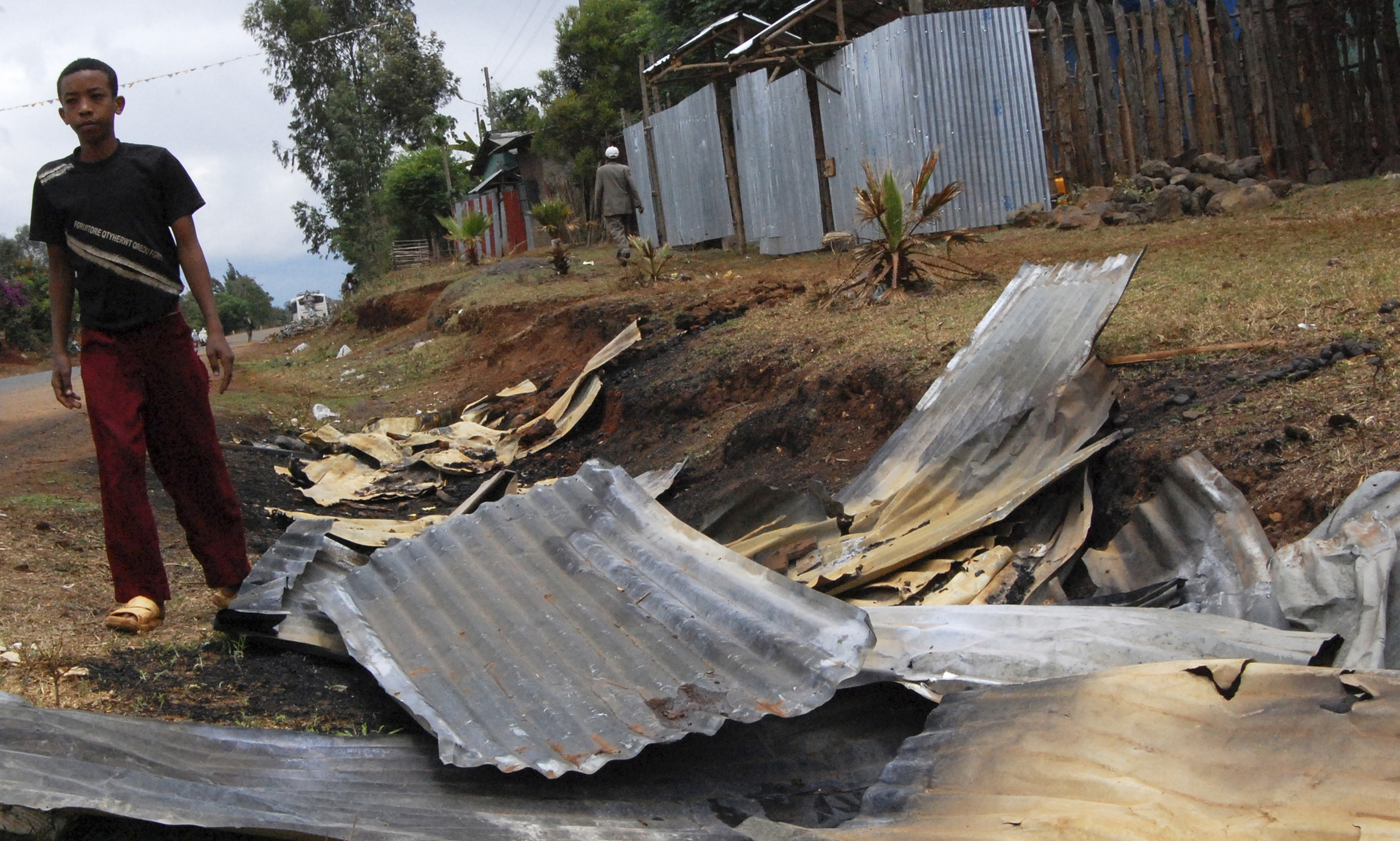 A boy walks near a destroyed church