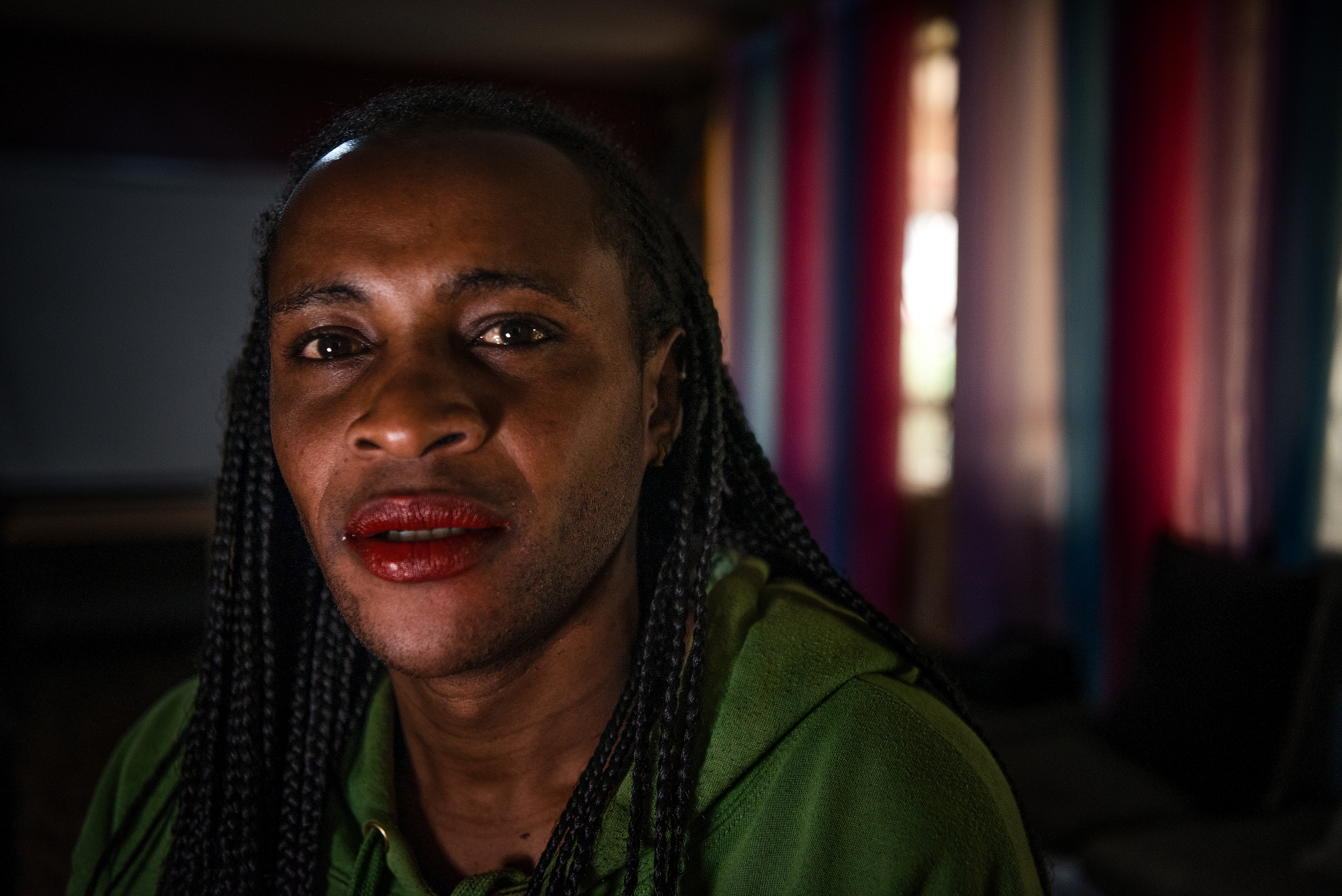 A Kenyan person with red lipstick poses for the camera