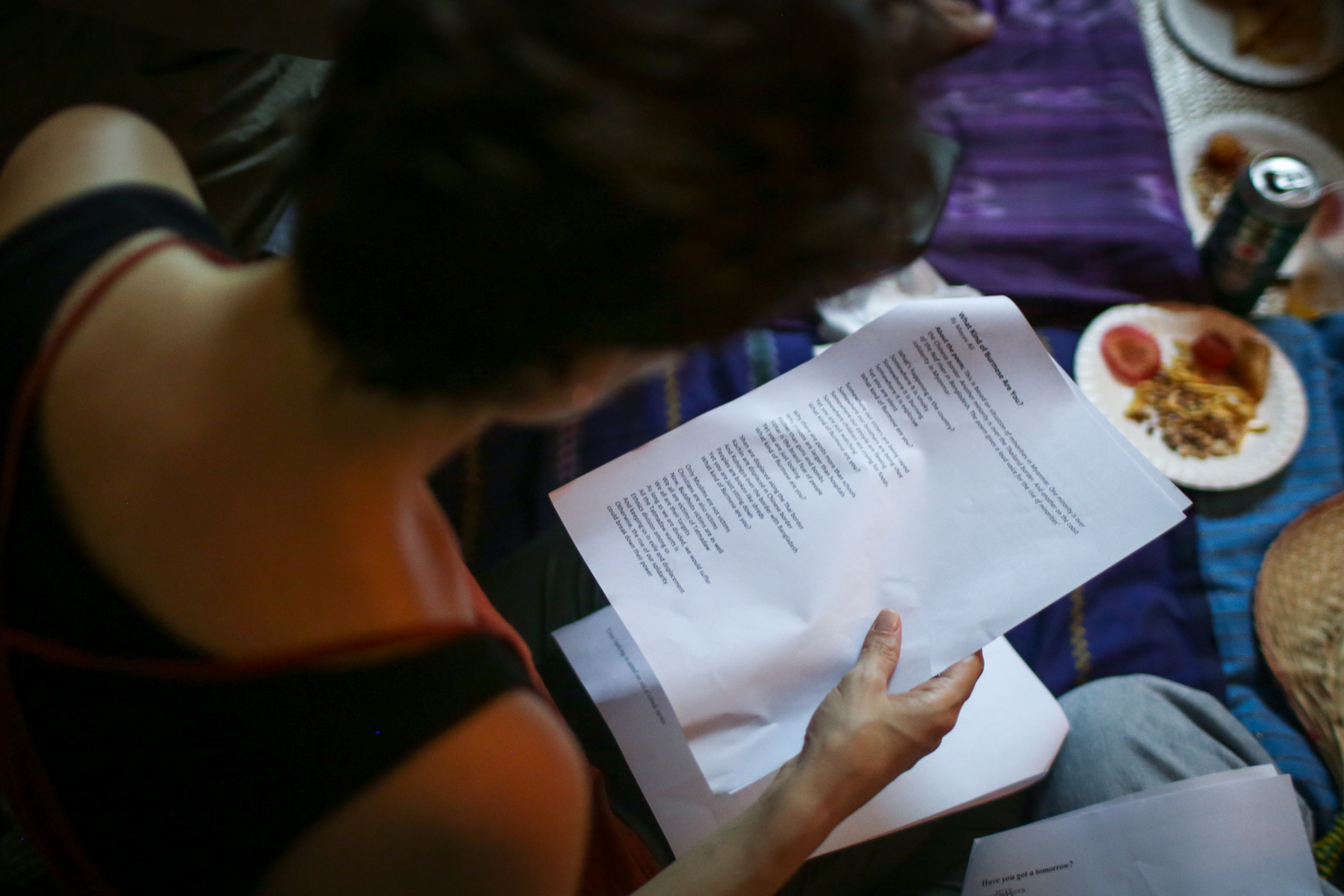 An audience member holds a paper with a poem in English on it