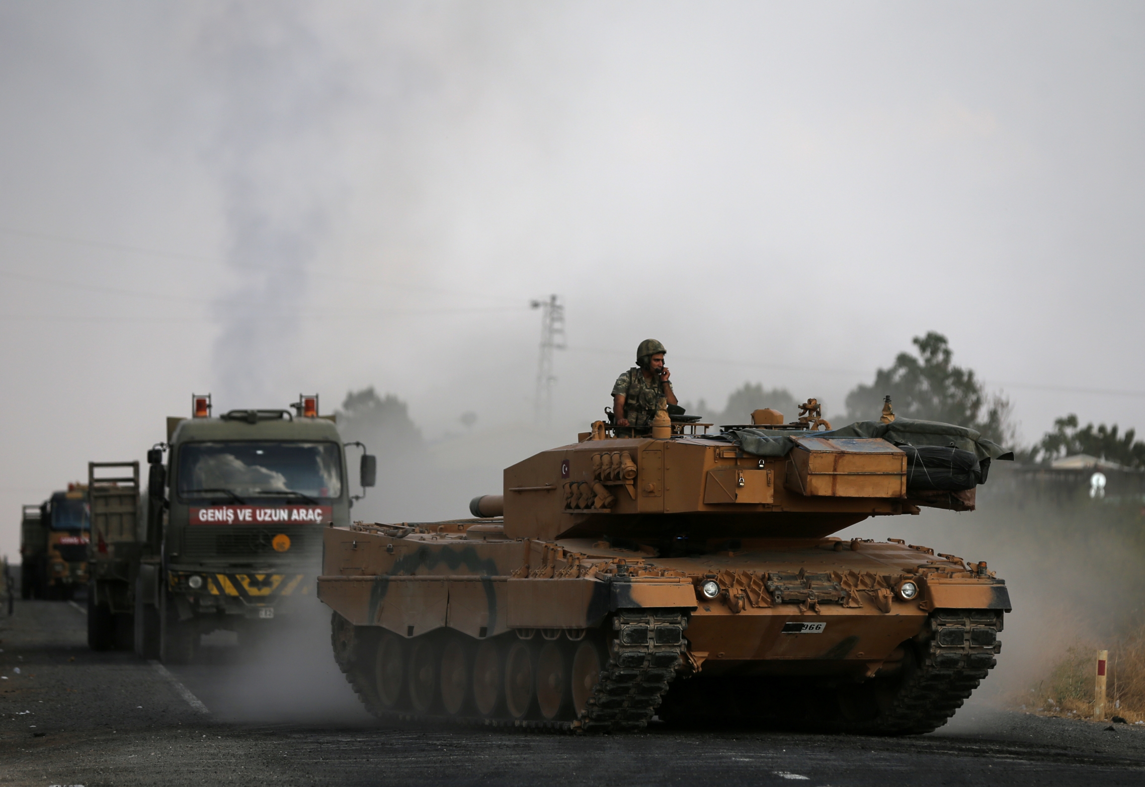 Turkish army vehicles are moving on a road near the Turkish border town of Ceylanpinar, Sanliurfa province, Turkey, Oct. 18, 2019. Turkish army vehicles