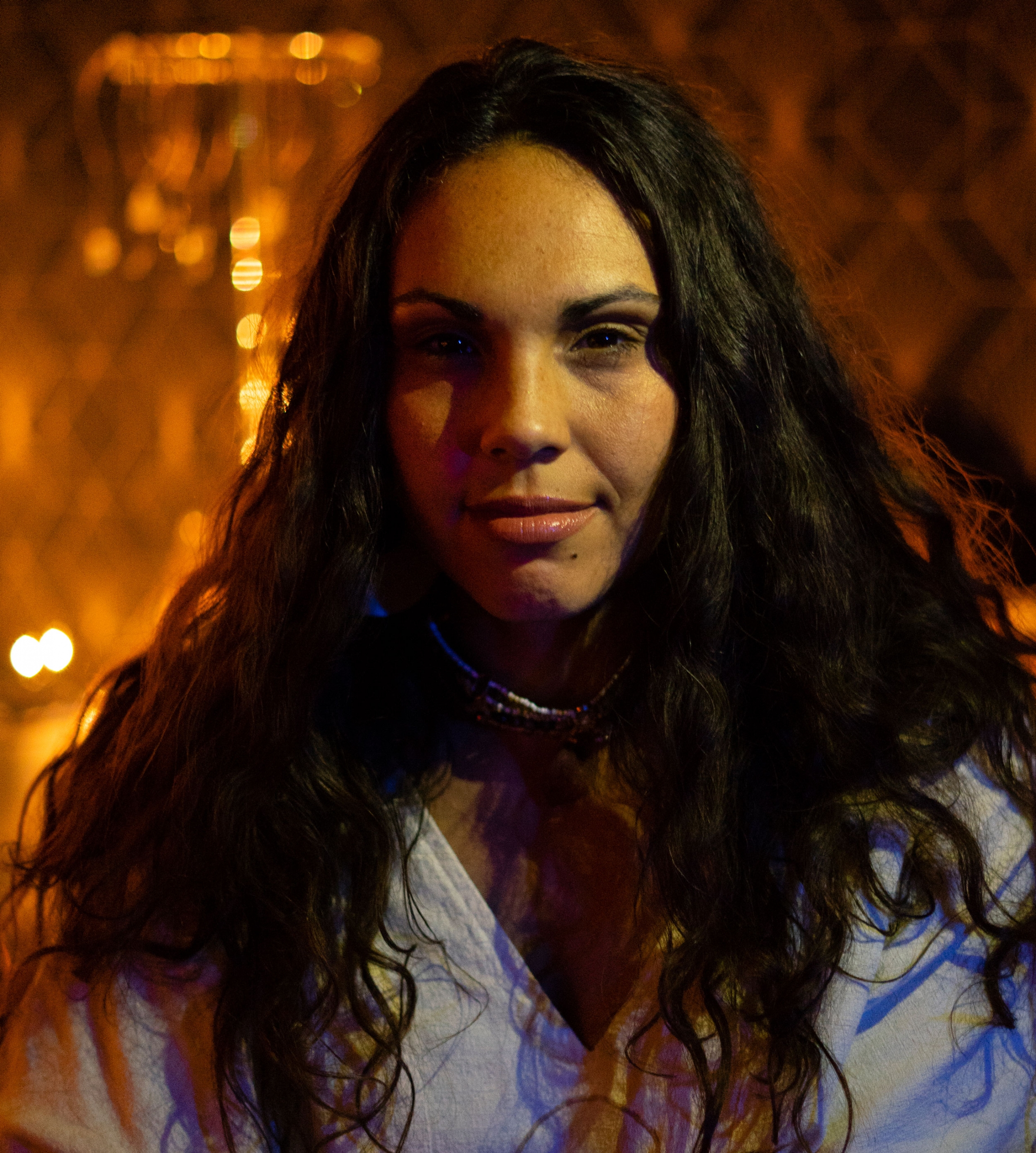 Jessica Freites is a conduit and offers other healing arts services. Jessica Freites is shown in a portrait photograph with long dark hair.