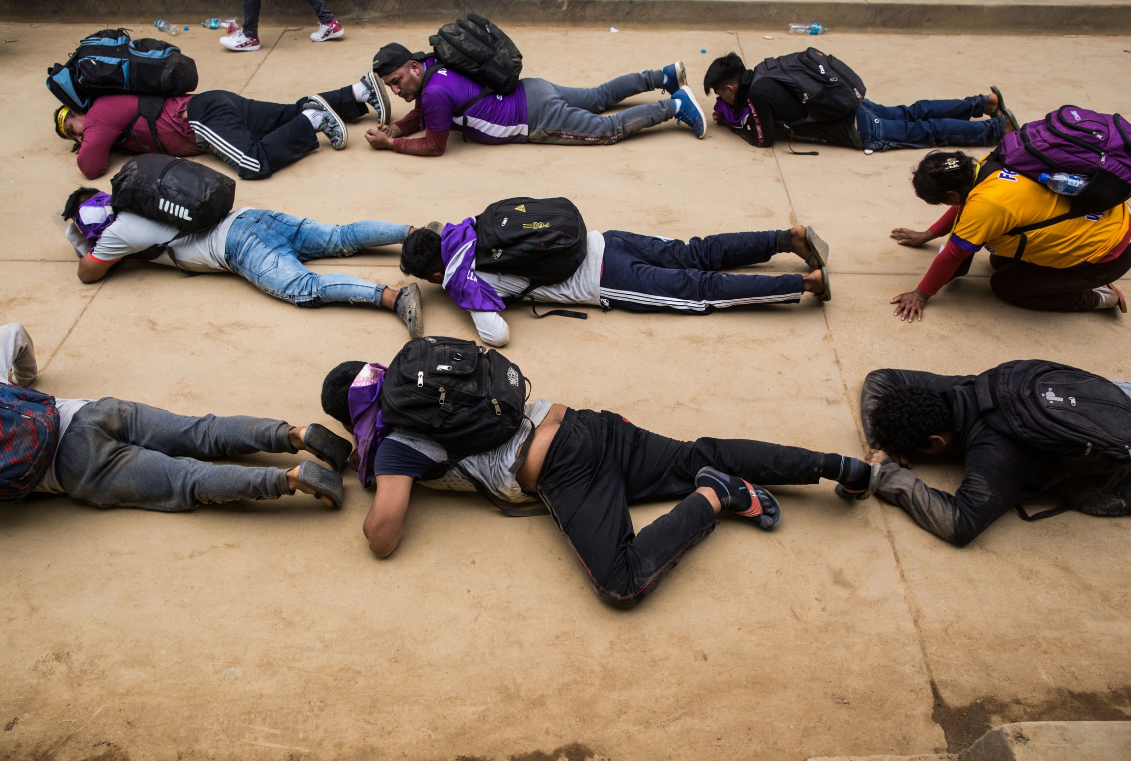 As a penance, Captive devotees crawl on the ground for more than 1,000 feet. Some people move backward, others are face down in an act of penance and crawl in gratitude for either a miracle granted or in hope for a miracle. Several people are shown crawling on their stomachs on the ground and wearing backpacks.