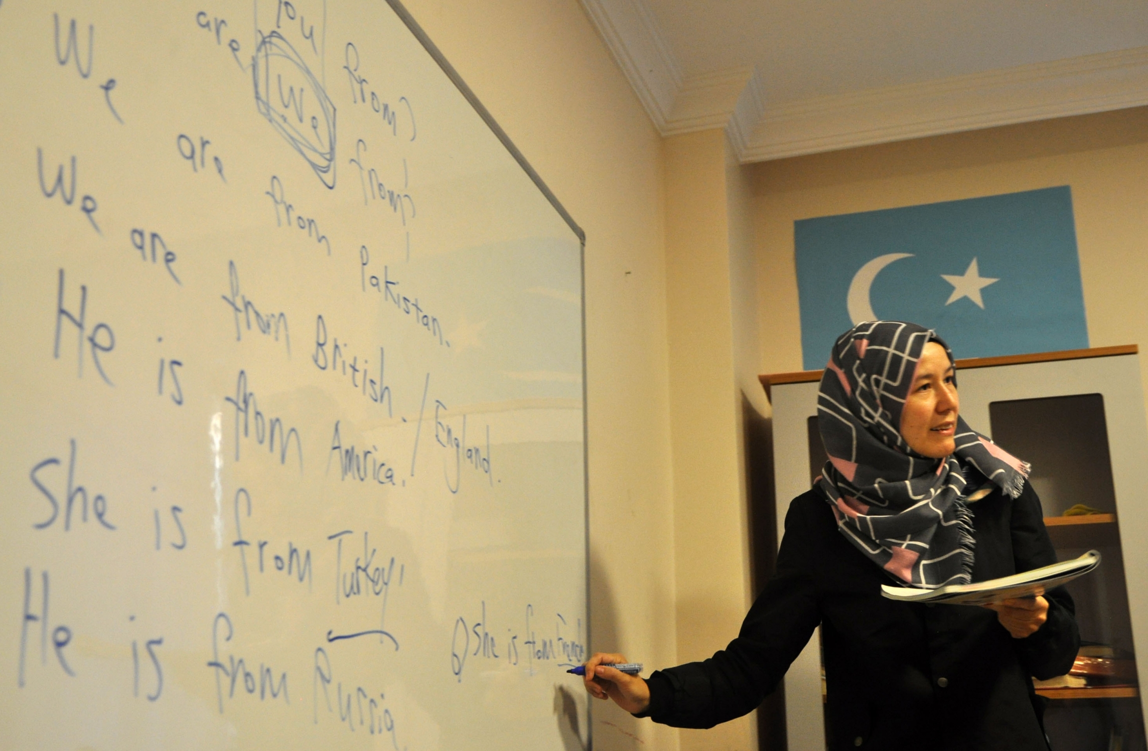 A teacher conducts an evening English class at Oku Uygur Bilig Yurdu, a school for Uighur children. A teacher conducts an evening English class at Oku Uygur Bilig Yurdu, a school for Uighur children.