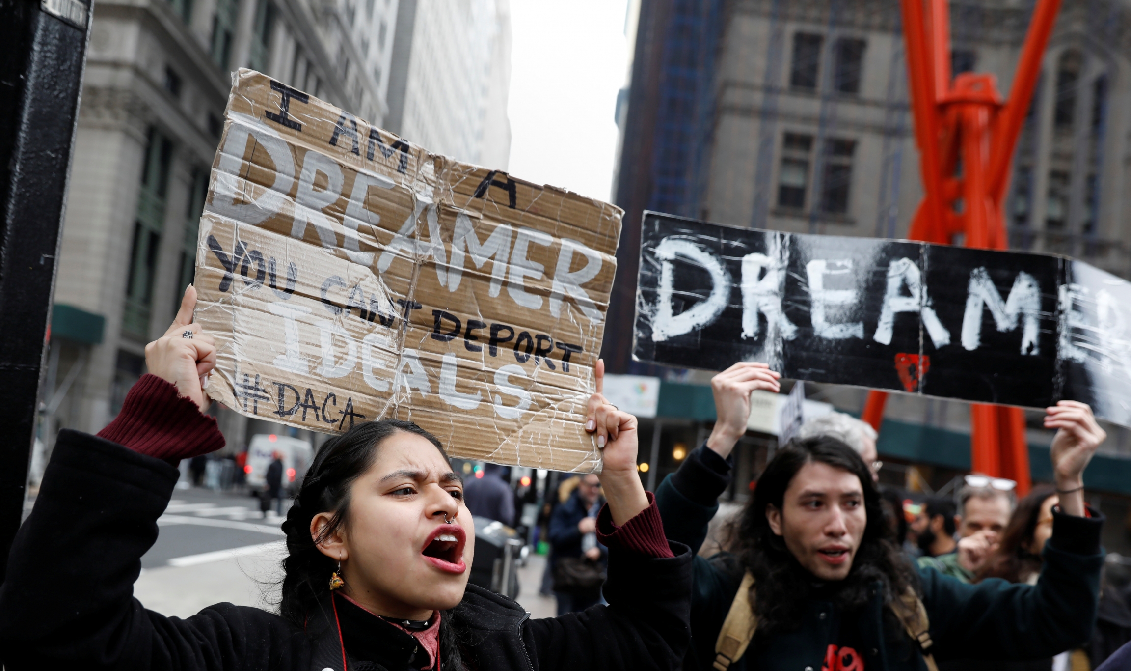 Activists and DACA recipients march up Broadway in New York holding signs. Activists and DACA recipients march up Broadway in New York holding signs.