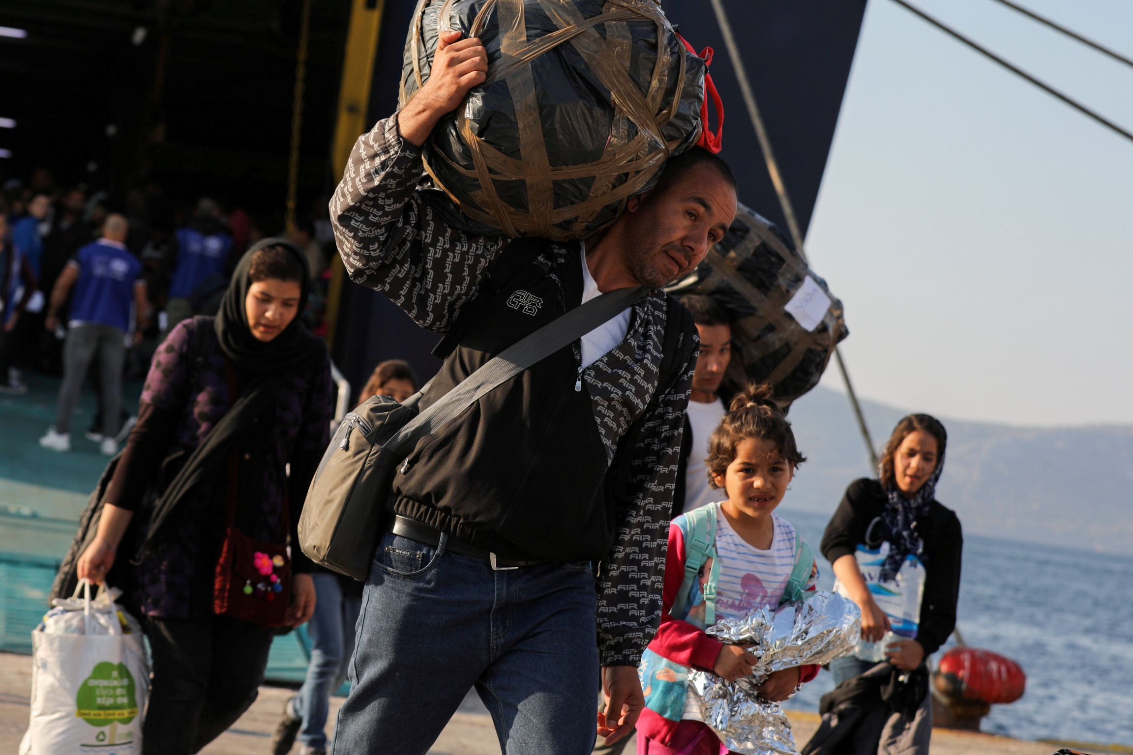 Refugees and migrants arrive aboard the Paros Jet passenger ship at the port of Elefsina near Athens, Greece, Oct. 22, 2019. Refugees and migrants arrive aboard the Paros Jet passenger ship at the port of Elefsina near Athens, Greece, Oct. 22, 2019.