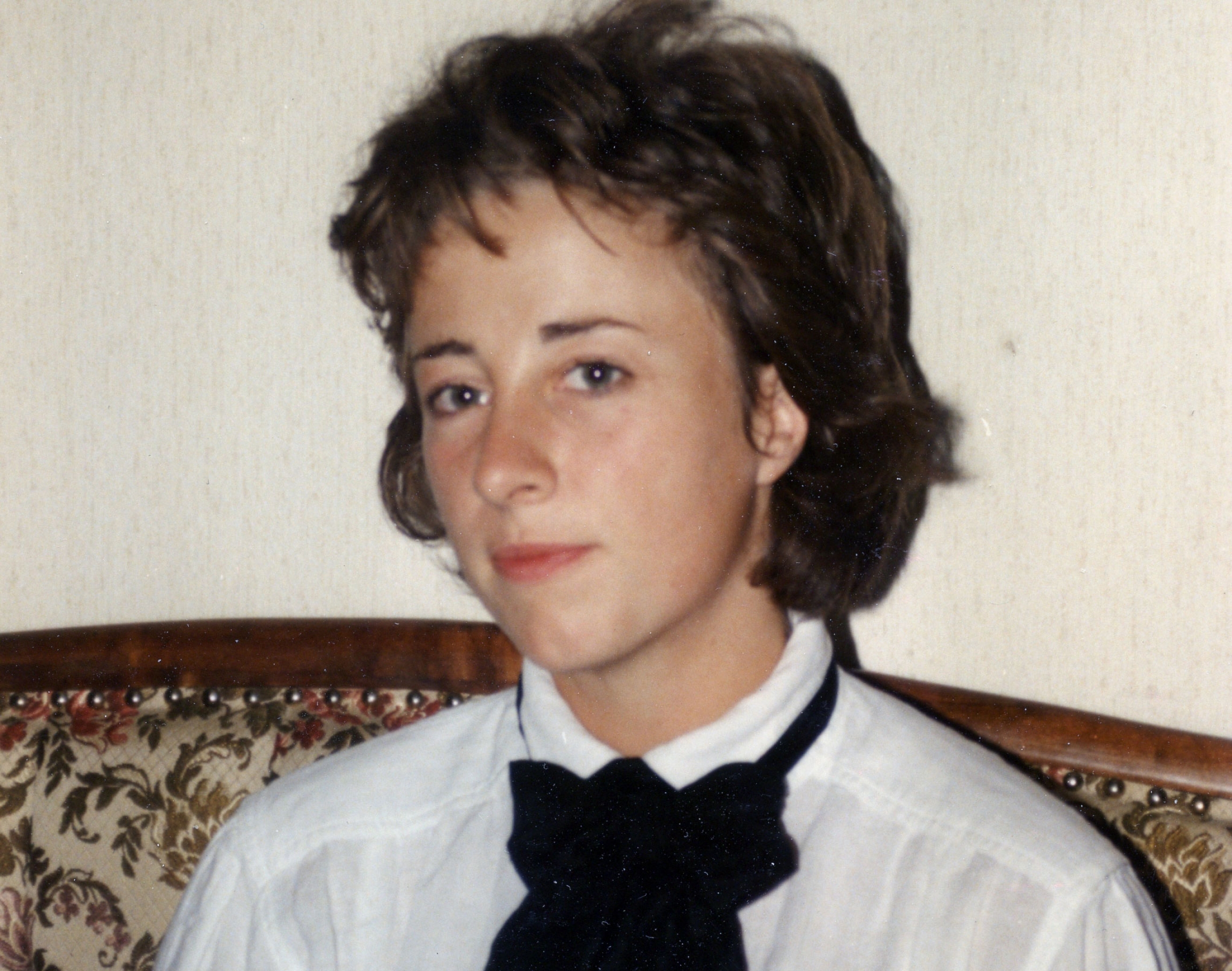 Gabi Hayes, age 22, from a photo taken in 1987 by Mark Hayes. A portrait photo of Gabi Hayes in a white shirt and black tie.