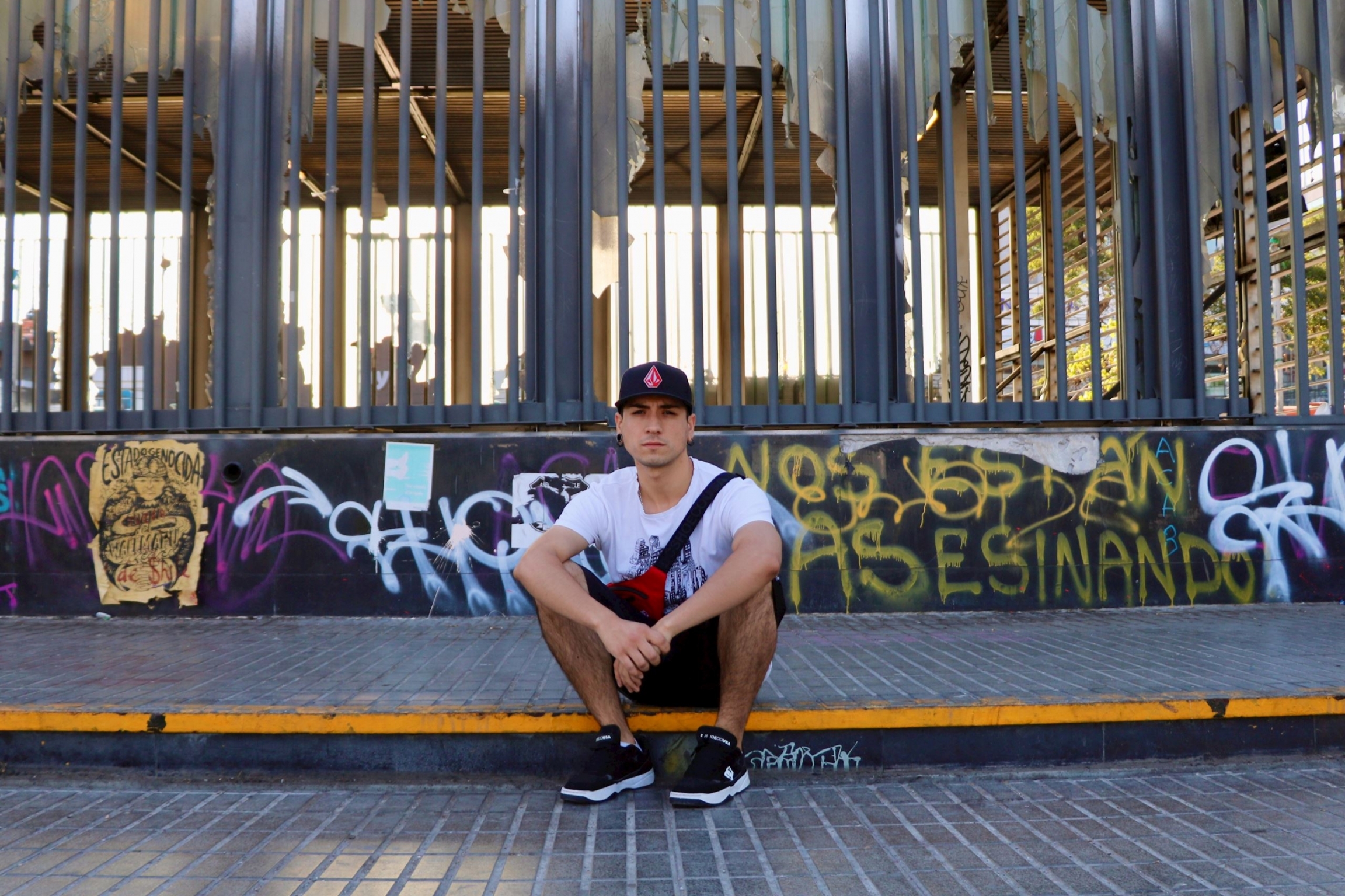 History student Frank Araneda, 23, takes a break from protesting at a vandalized metro station in Maipú, a low-income neighborhood outside of Santiago, Chile. History student Frank Araneda, 23, takes a break from protesting at a vandalized metro station in Maipú, a low-income neighborhood outside of Santiago, Chile.