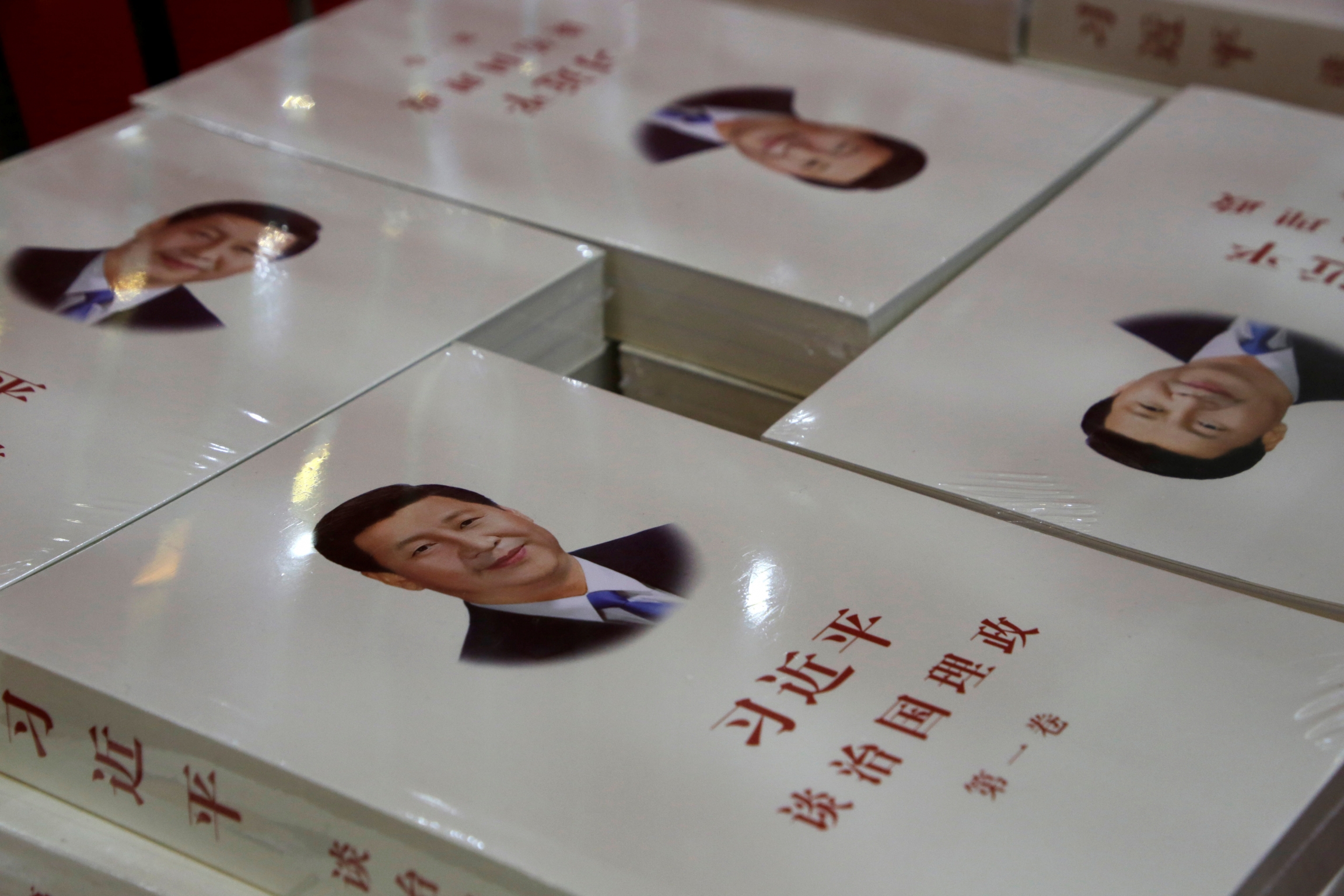 Copies of book "Xi Jinping: The Governance of China," are displayed for sale at a bookstore in Beijing, China, March 1, 2018. Copy of books with president's face