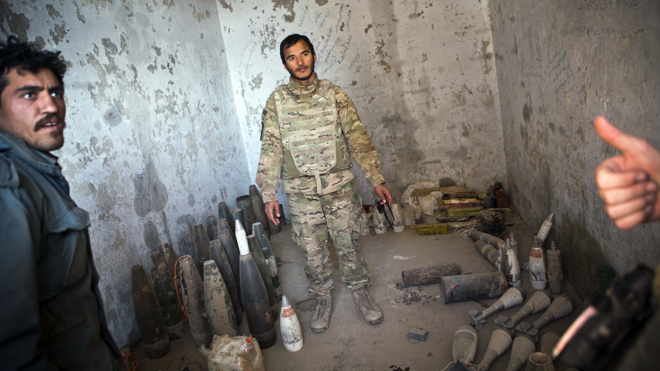 A translator for the US Army speaks to a member of the US Army's 52nd Ordinance Group, 63rd Ordinance Battalion, 766 Explosive Ordinance Disposal company as they collect confiscated improvised explosive devices (IEDs). A translator for the US Army speaks to a member of the US Army's 52nd Ordinance Group, 63rd Ordinance Battalion, 766 Explosive Ordinance Disposal company as they collect confiscated improvised explosive devices (IEDs).