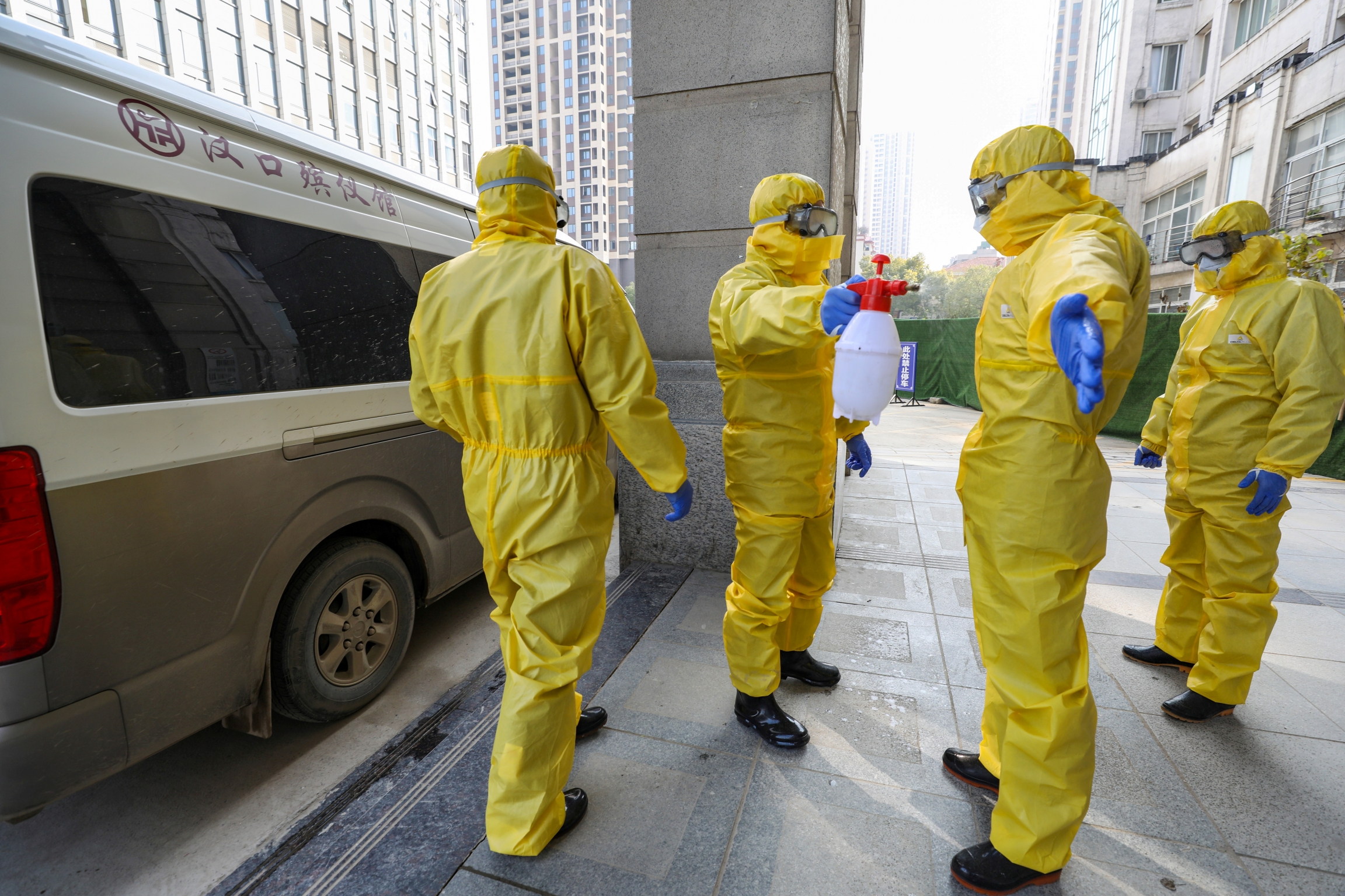 Funeral parlor staff members in protective suits help a colleague with disinfection after they transferred a body at a hospital, following the outbreak of a new coronavirus in Wuhan, Hubei province, China, Jan. 30, 2020. Funeral parlor staff members in protective suits help a colleague with disinfection after they transferred a body at a hospital, following the outbreak of a new coronavirus in Wuhan, Hubei province, China, Jan. 30, 2020.